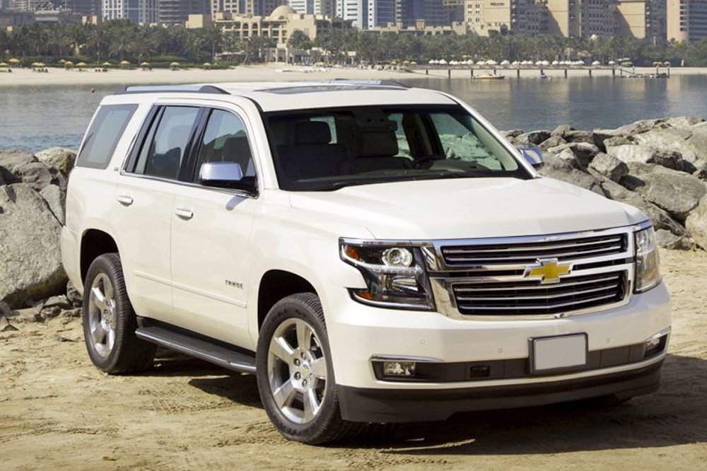 White Chevrolet Tahoe SUV parked on a beach