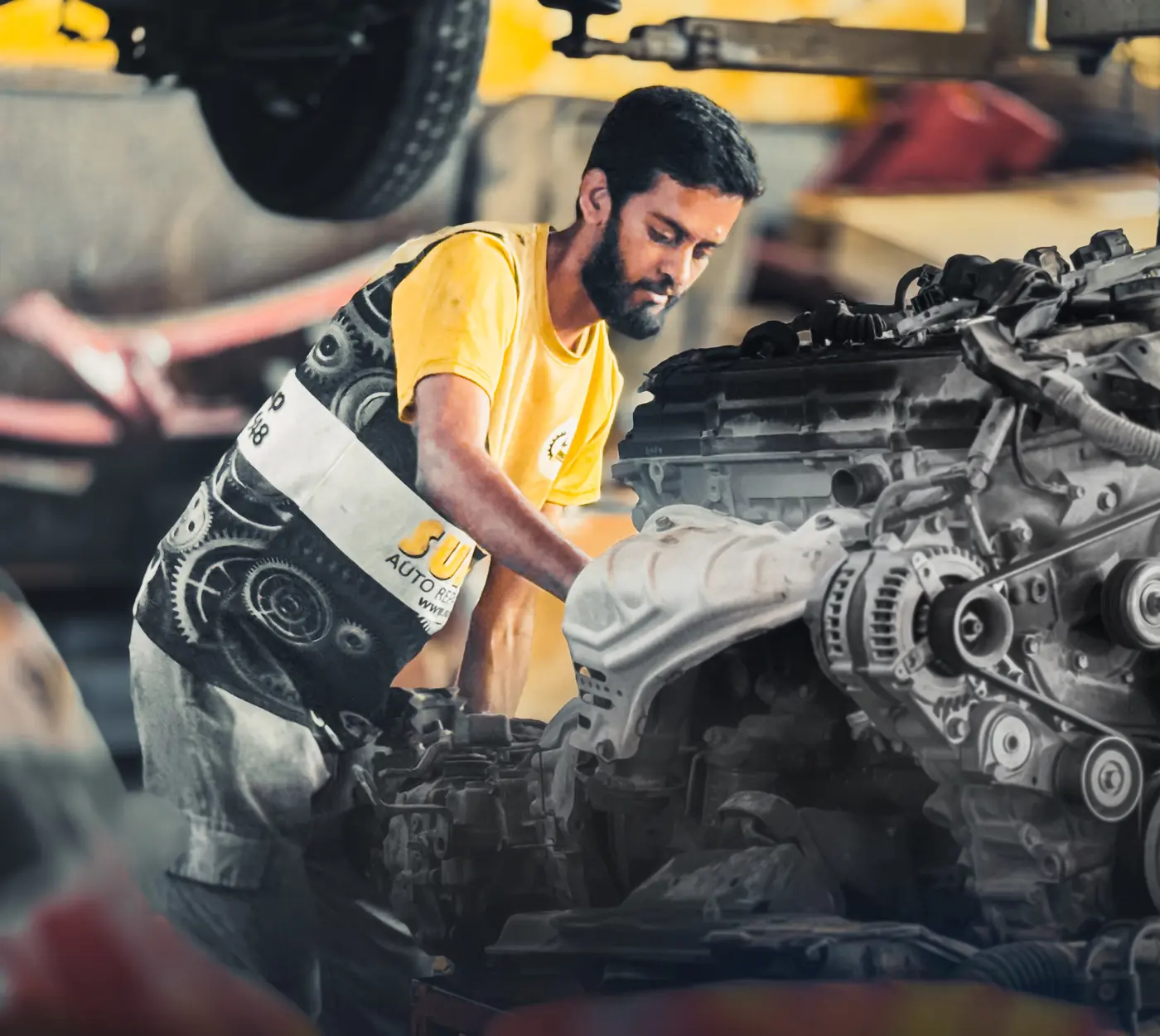 Sunshine Auto mechanic carrying out an engine repair in the workshop